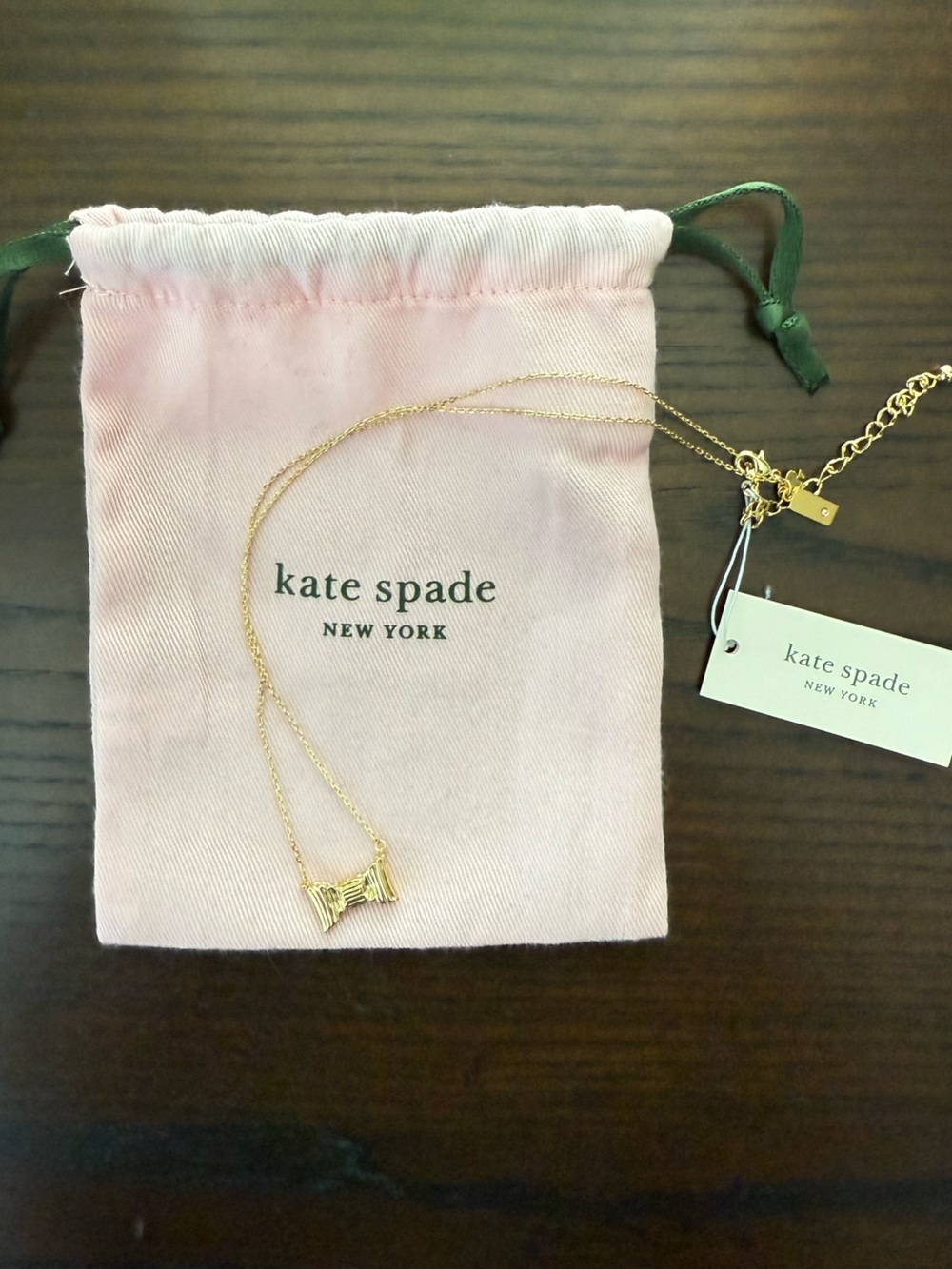 Kate Spade Gold Bow Necklace with pink pouch